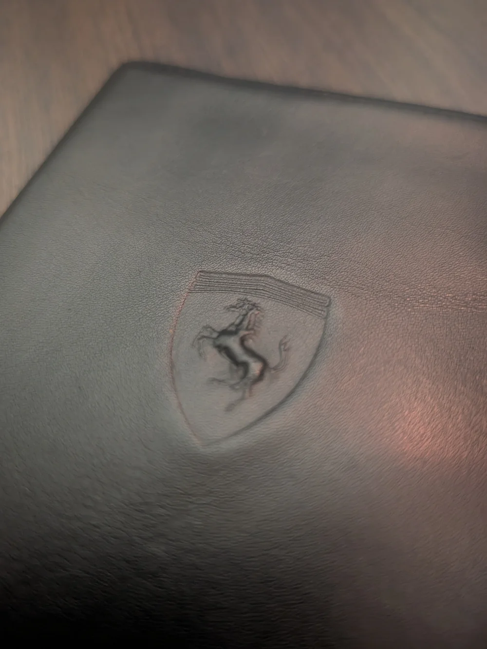 FERRARI Black Leather Passport Wallet with Embossed Shield Logo Red Inside